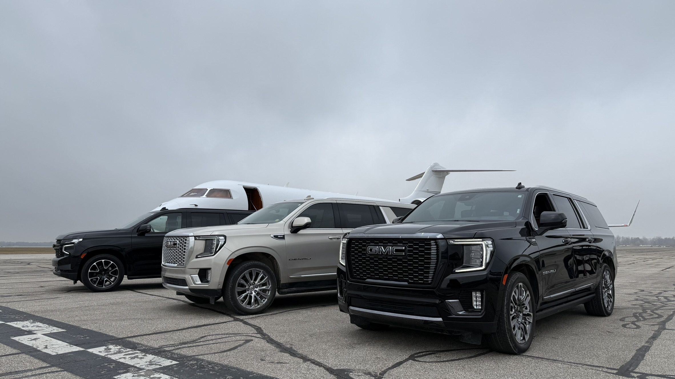 LuxeDetroit vehicles lined up at a private aviation terminal