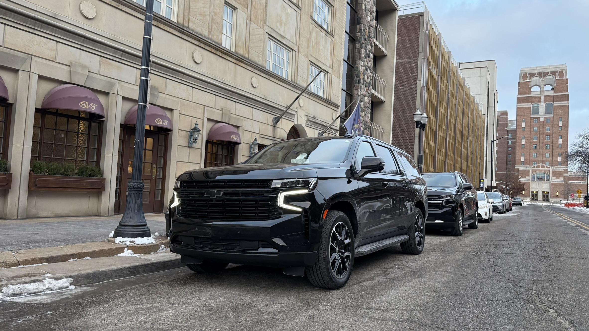 LuxeDetroit vehicles at a hotel entrance
